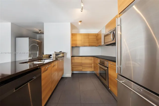 a bathroom with a sink a large mirror and a stove