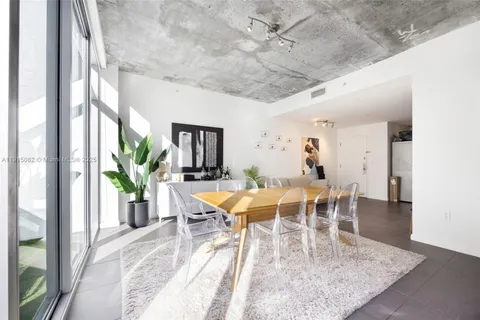 a view of a dining room with furniture and a potted plant