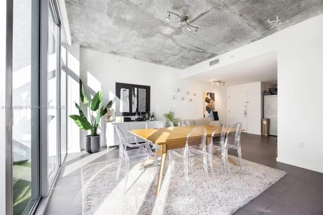 a view of a dining room with furniture and a potted plant