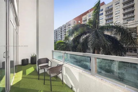 a balcony with table and chairs