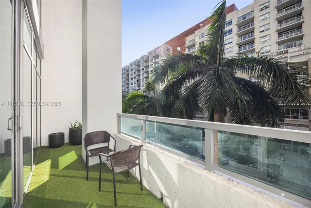 a balcony with table and chairs