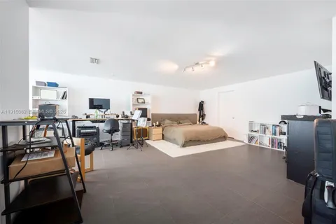 a bedroom with furniture and a flat screen tv