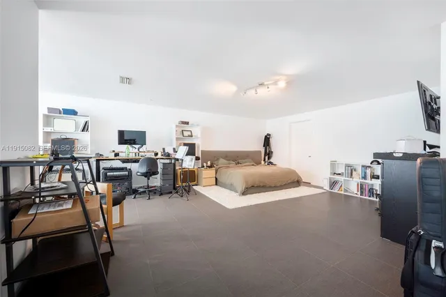 a bedroom with furniture and a flat screen tv