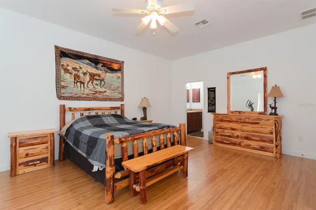 a bedroom with furniture and wooden floor