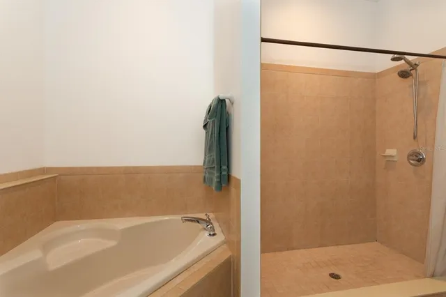 a bathroom with a shower and a bath tub