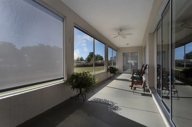 a view of a balcony with chairs and a potted plant on the wall