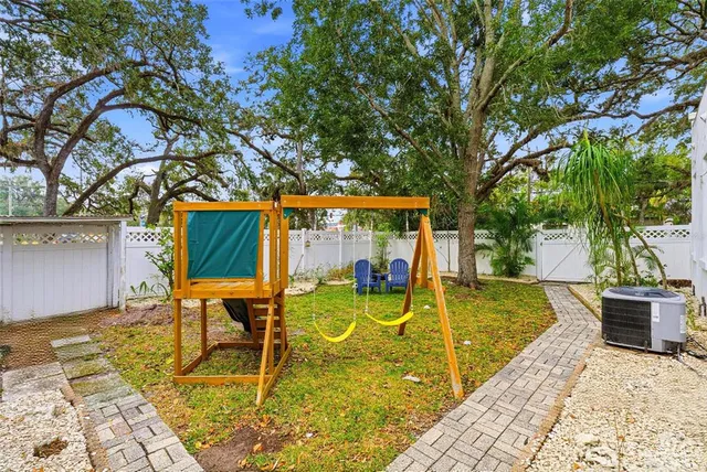a swimming pool with outdoor seating and yard