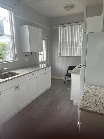 a kitchen with a sink and cabinets