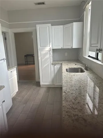 a kitchen with a sink and cabinets