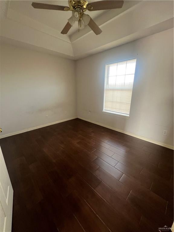 704 Thompson Road, Unit 1 Mission, TX 78573 - Photo 12 of 13 an empty room with wooden floor fan and windows