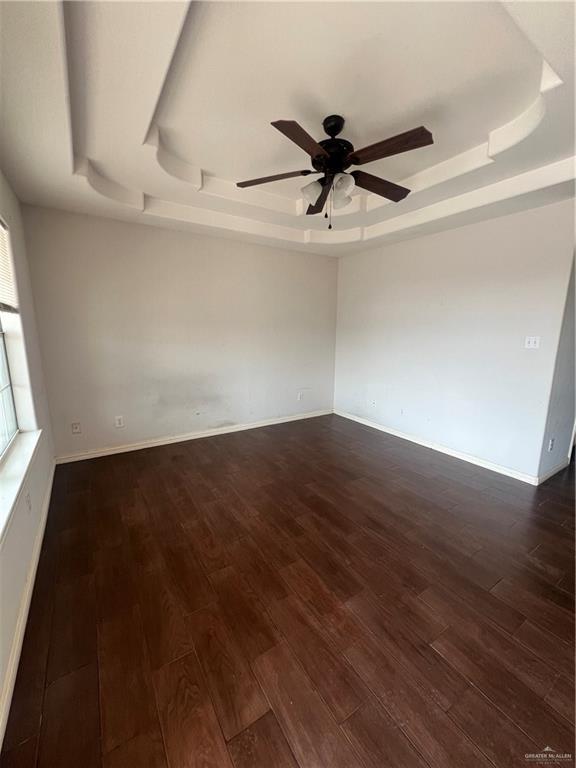 704 Thompson Road, Unit 1 Mission, TX 78573 - Photo 2 of 13 an empty room with wooden floor fan and windows