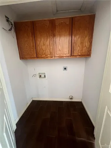 a view of kitchen with wooden floor and cabinets