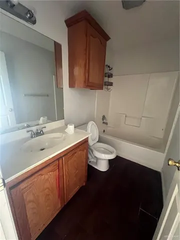 a bathroom with a sink a toilet and mirror