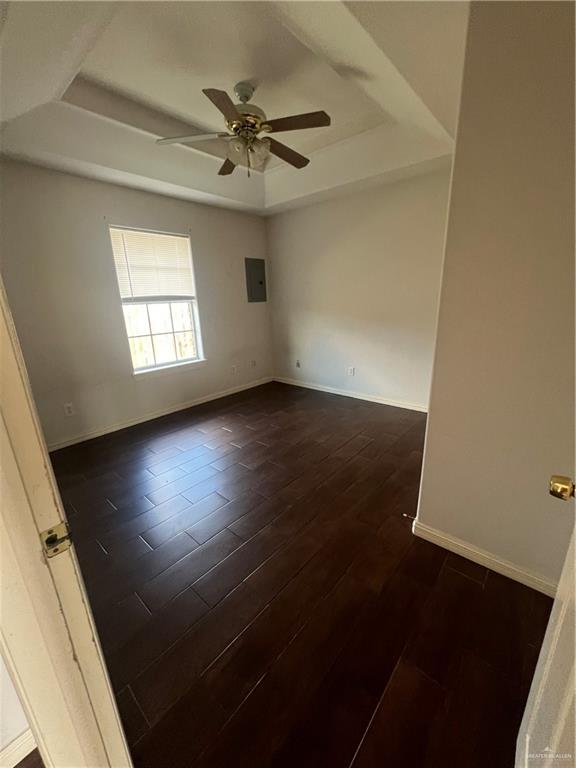 704 Thompson Road, Unit 1 Mission, TX 78573 - Photo 10 of 13 an empty room with wooden floor fan and windows