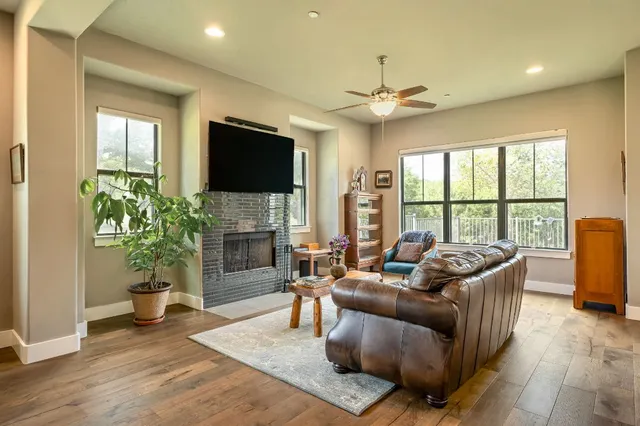 a living room with furniture a fireplace and a flat screen tv