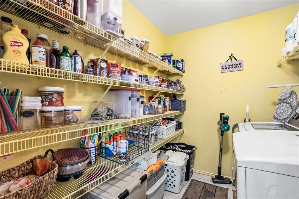 2701 Rudder Lane McKinney, TX 75071 - Photo 16 of 21 Utility room serves as pantry with tons of shelving