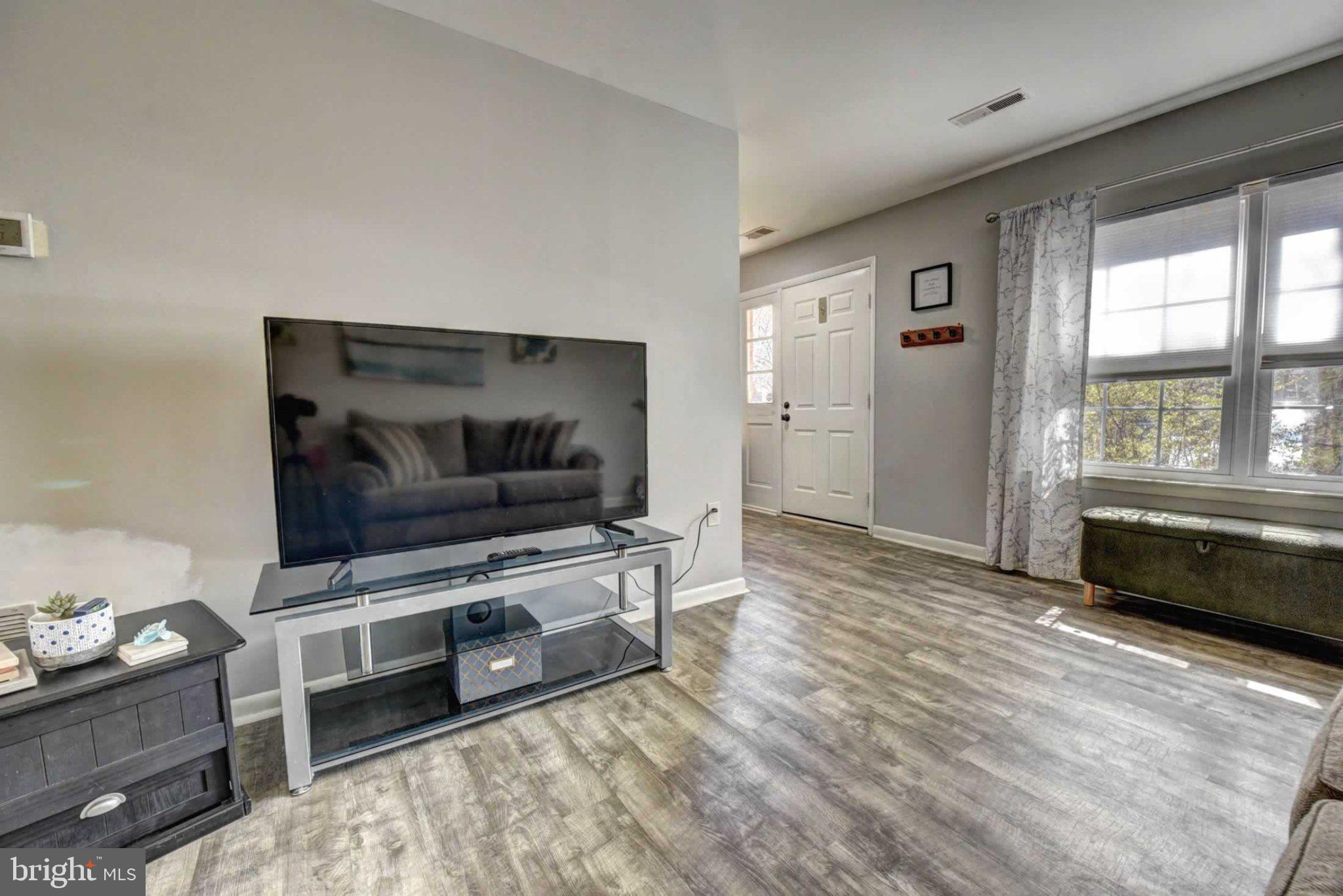 2226 Gunsmith Square Reston, VA 20191 - Photo 3 of 35 a living room with furniture and a flat screen tv