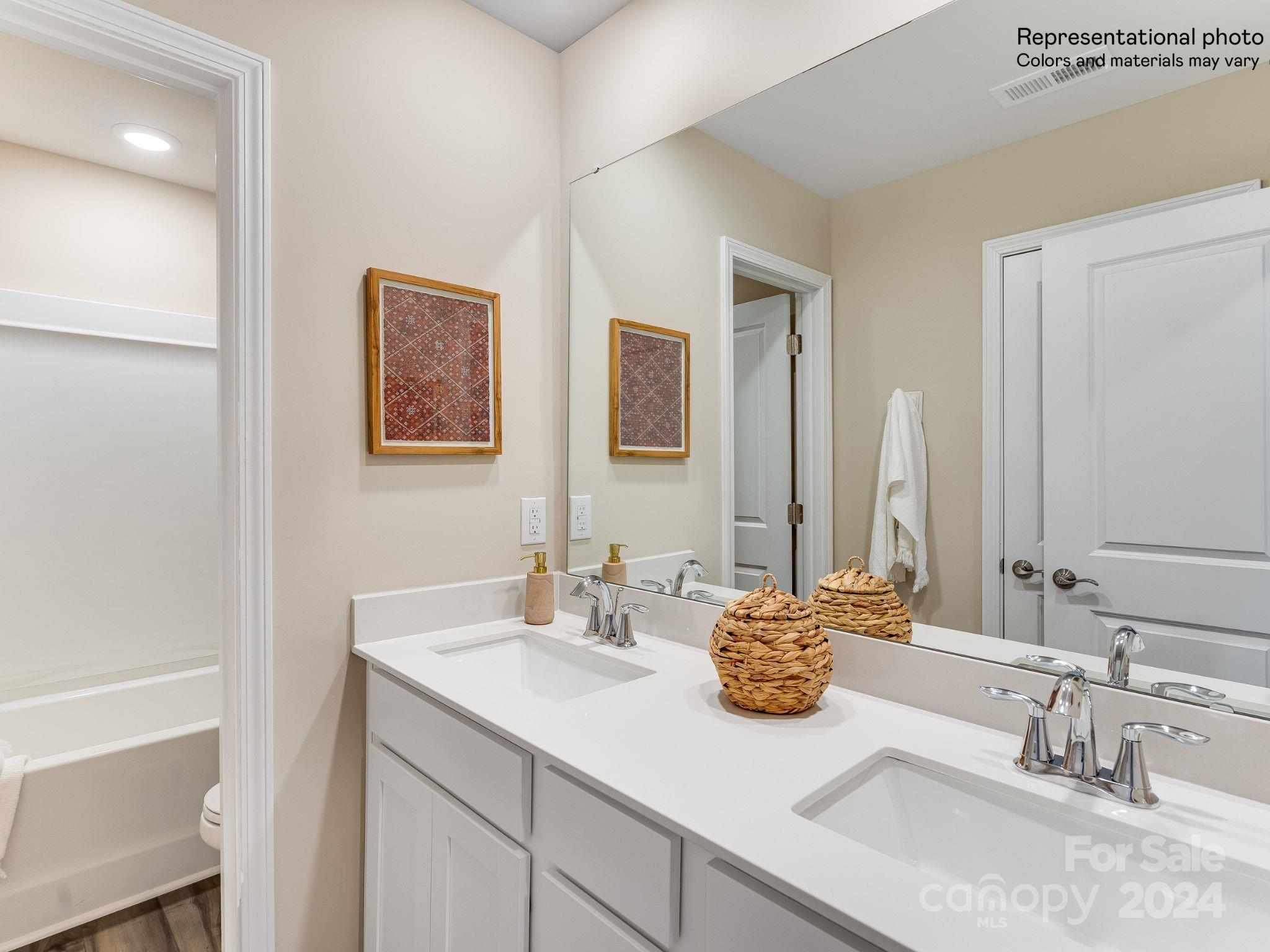 15126 Windy Plns Road Charlotte, NC 28262 - Photo 19 of 23 a bathroom with a sink and a mirror