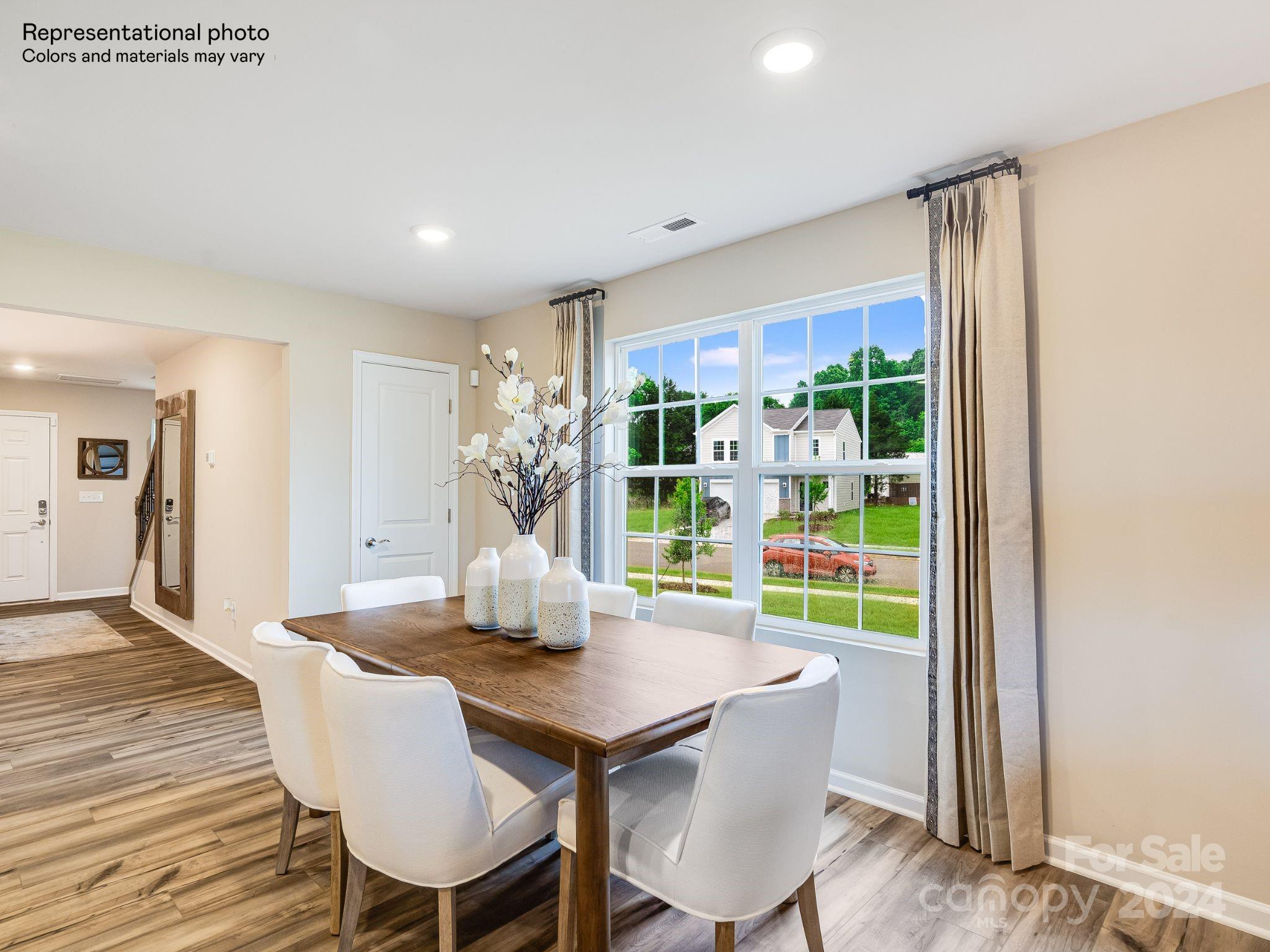 15126 Windy Plns Road Charlotte, NC 28262 - Photo 10 of 23 a view of a dining room with furniture window and wooden floor