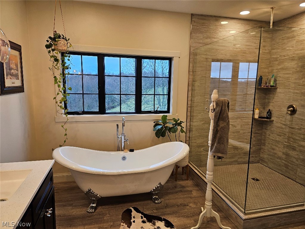 25073 Ridge Road East Rochester, OH 44625 - Photo 31 of 37 Bathroom with vanity, independent shower and bath, and hardwood / wood-style flooring