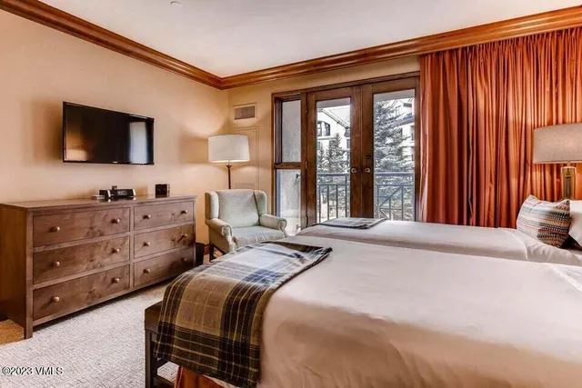 a bedroom with a bed and a television