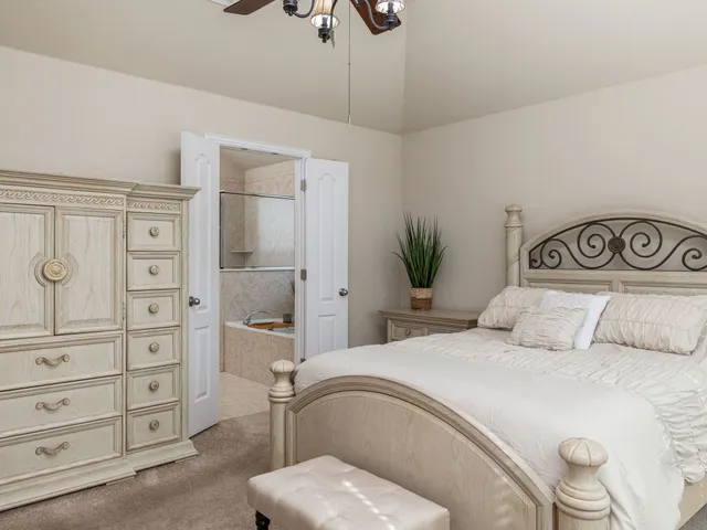 a bedroom with a large bed and a dresser