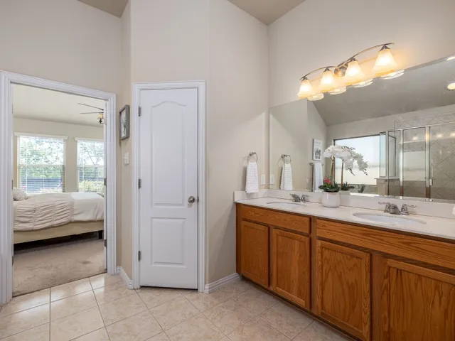 a en suite bathroom with a tub sink and mirror