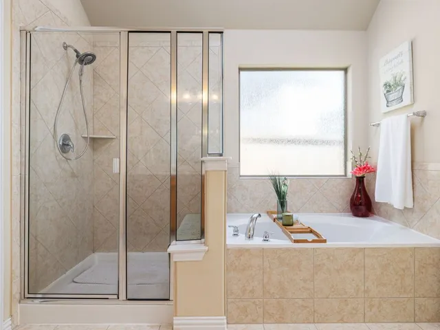 a bathroom with a tub sink and shower