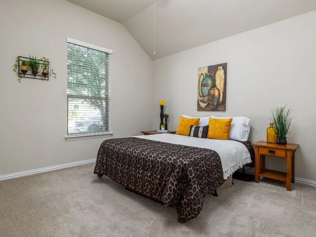 a bedroom with bed and window
