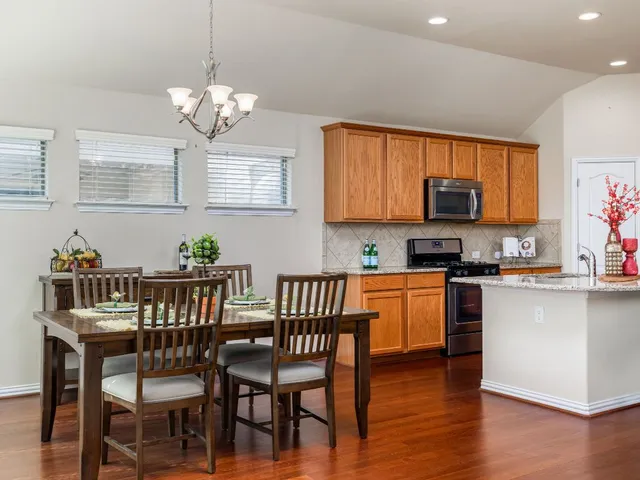a view of a dining room with furniture wooden floor and a chandelier