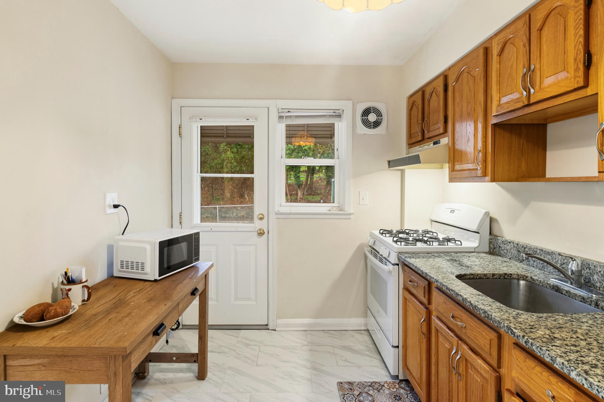 166 Cherrydell Road Baltimore, MD 21228 - Photo 14 of 24 a kitchen that has a sink and a stove in it