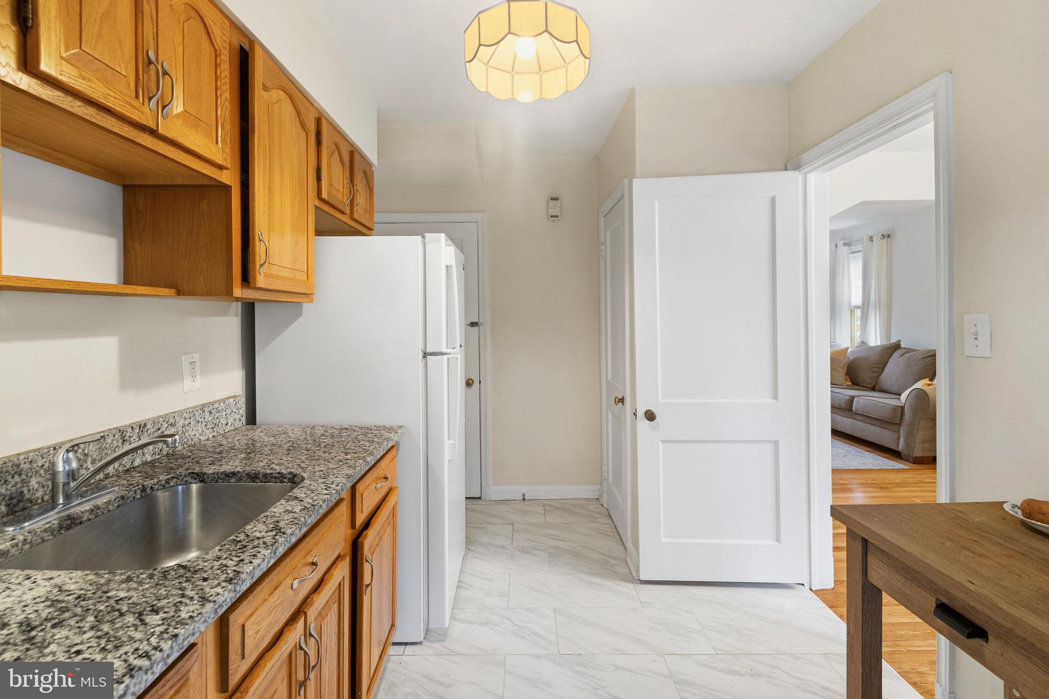 166 Cherrydell Road Baltimore, MD 21228 - Photo 16 of 24 a kitchen that has a sink a microwave a refrigerator and a stove