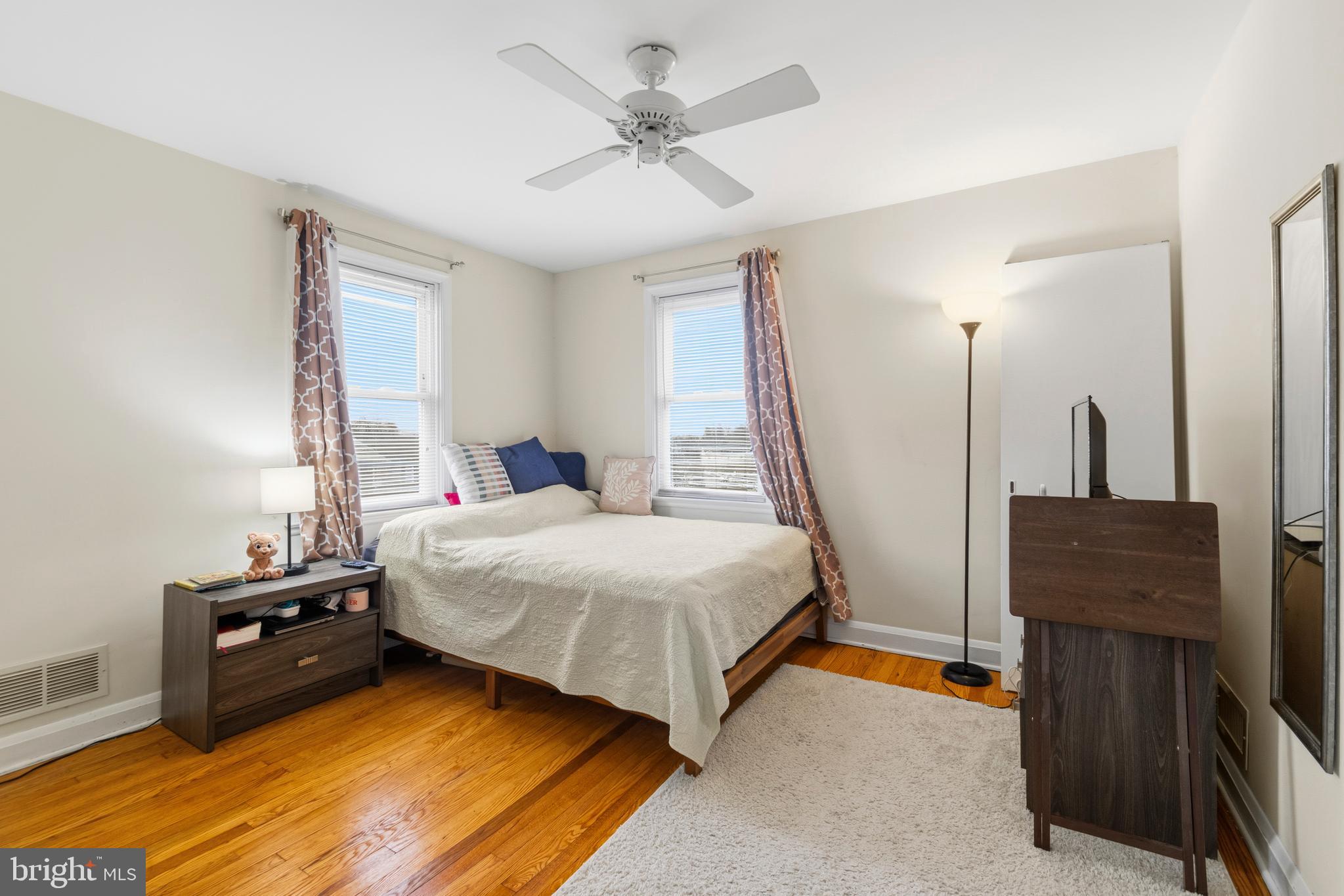 166 Cherrydell Road Baltimore, MD 21228 - Photo 17 of 24 a bedroom with a bed and a flat tv screen on the dresser