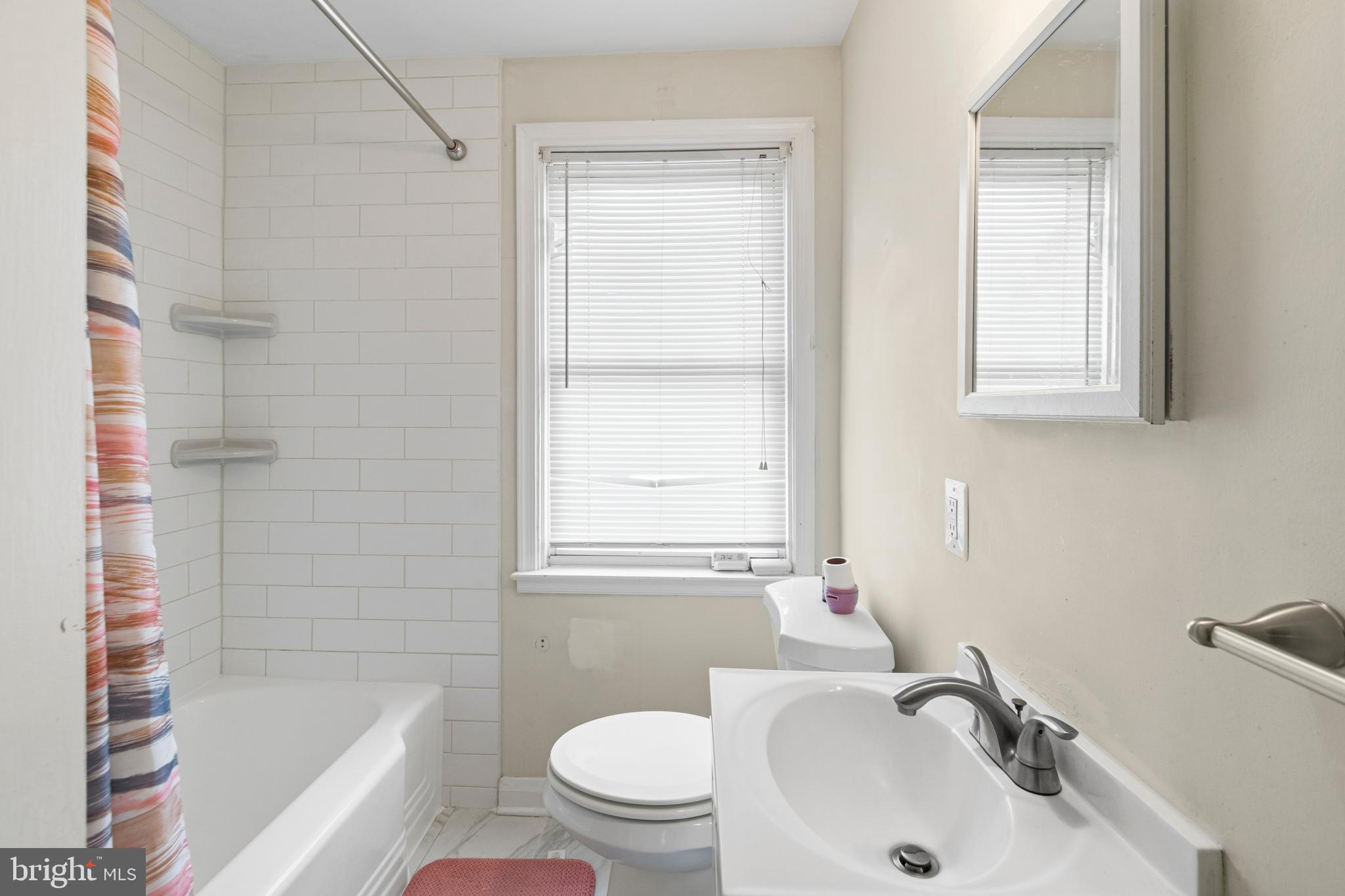 166 Cherrydell Road Baltimore, MD 21228 - Photo 19 of 24 a bathroom with a sink and a bathtub