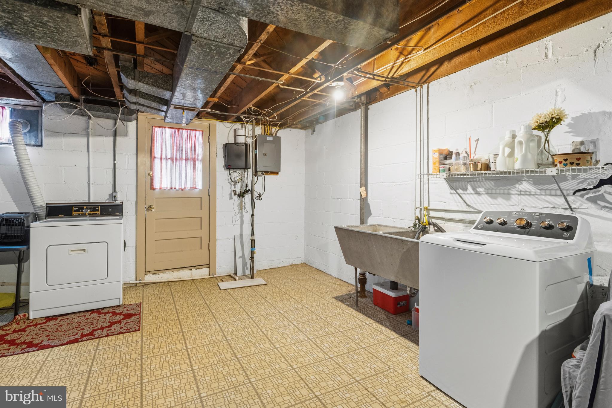 166 Cherrydell Road Baltimore, MD 21228 - Photo 23 of 24 a view of storage and utility room with washer and dryer