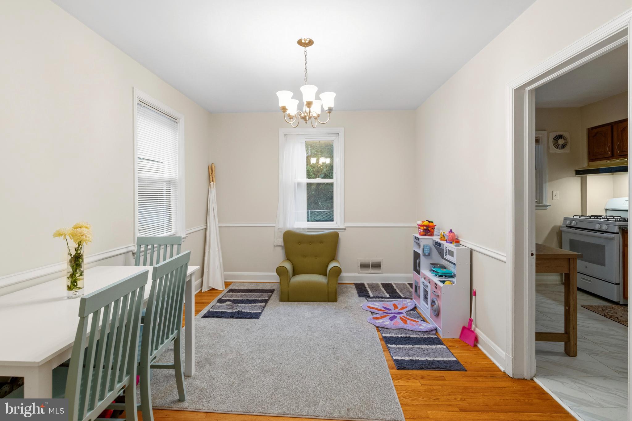 166 Cherrydell Road Baltimore, MD 21228 - Photo 10 of 24 a bedroom with furniture and a chandelier