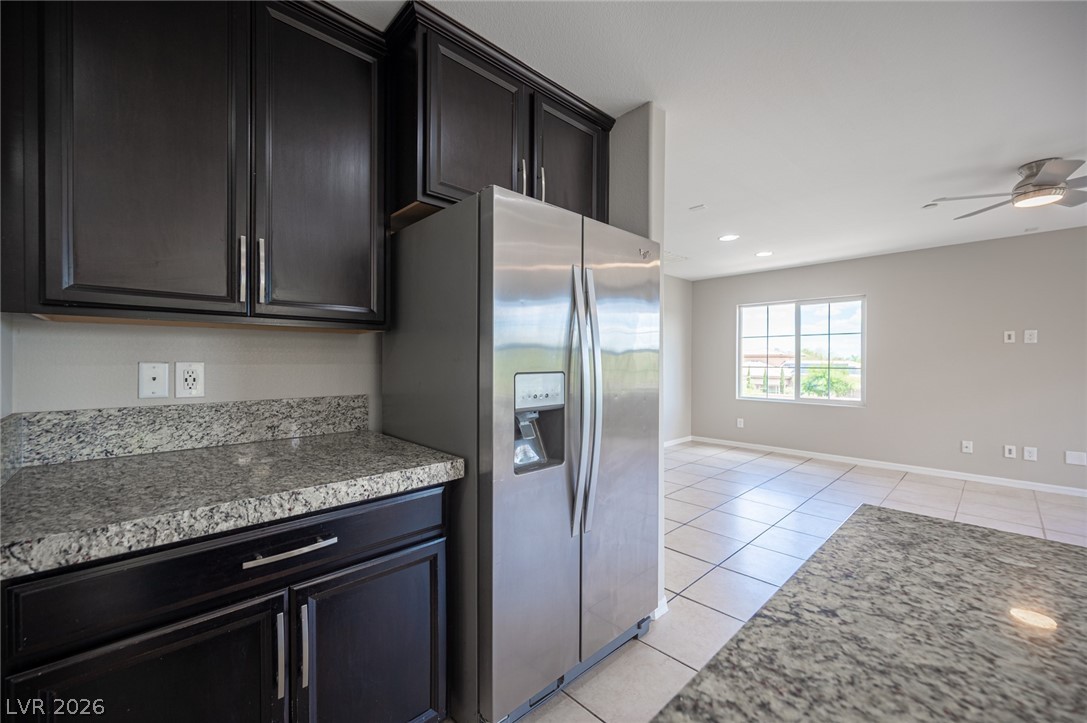 9916 Sable Point Street Las Vegas, NV 89178 - Photo 36 of 73 Granite counters and stainless steel appliances complete this well-appointed kitchen, seamlessly connecting to the living area.