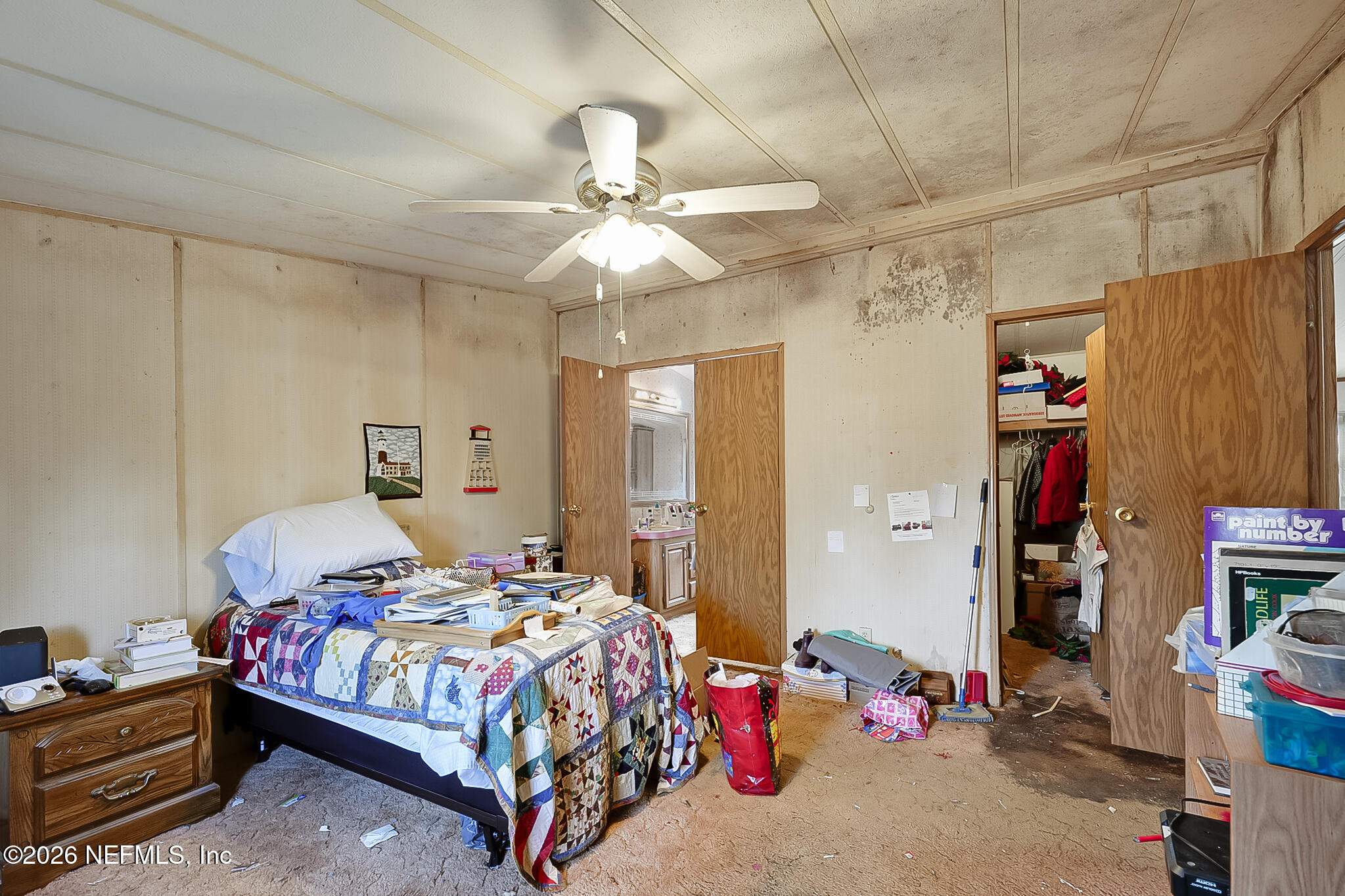 85110 Theresa Road Yulee, FL 32097 - Photo 13 of 24 a bedroom with bed and a chandelier