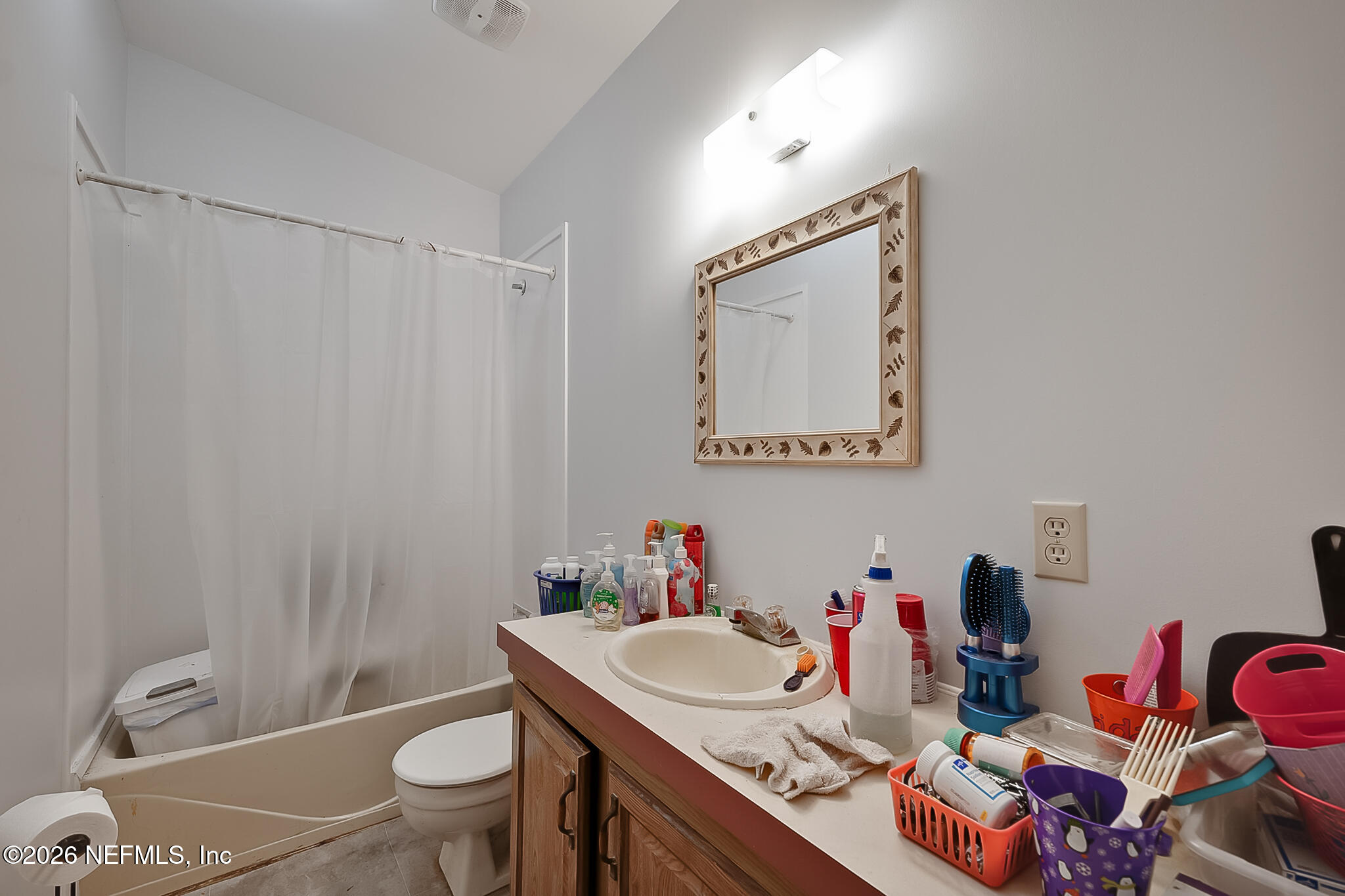 85110 Theresa Road Yulee, FL 32097 - Photo 18 of 24 a bathroom with a sink vanity mirror and toilet