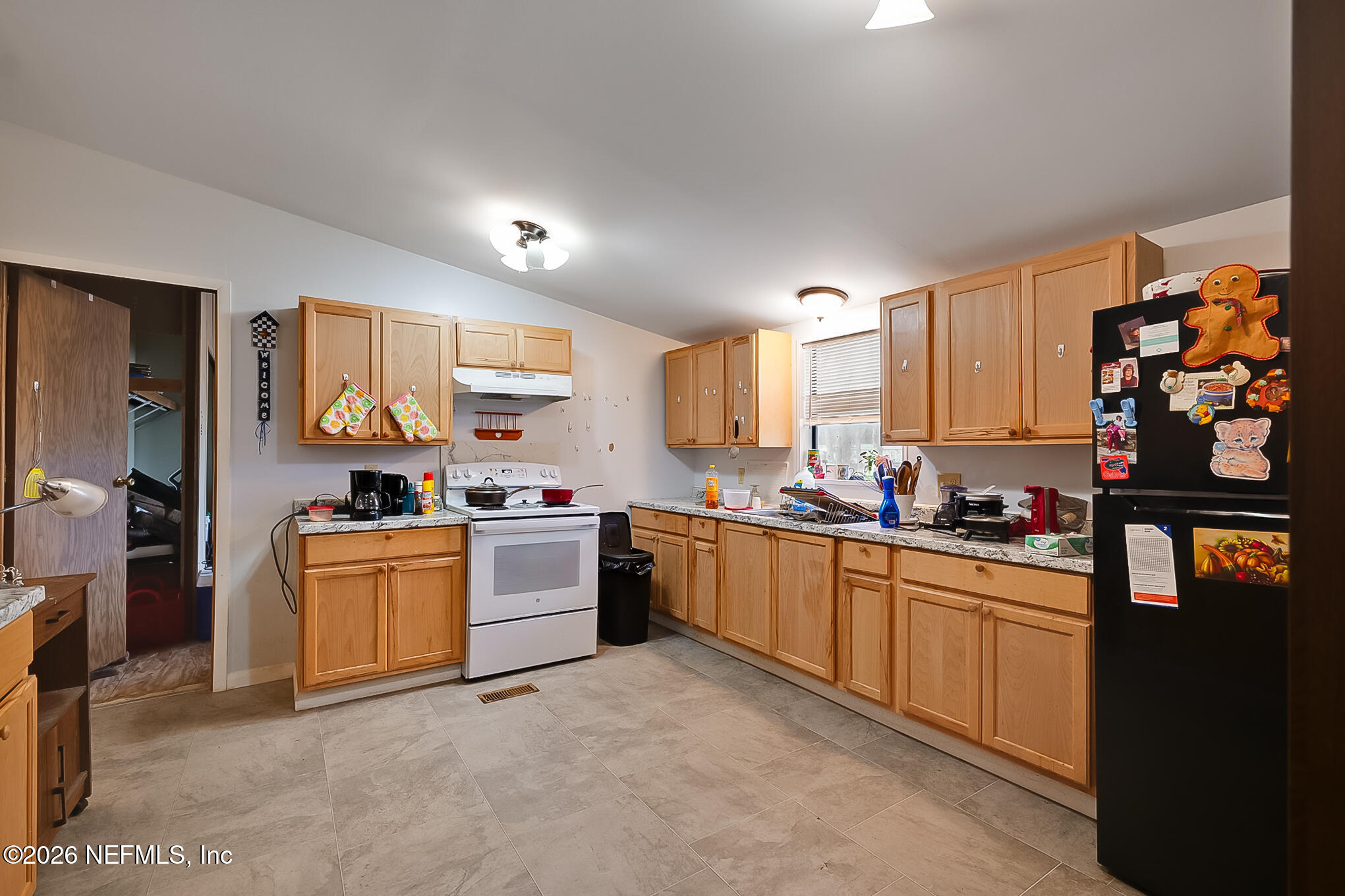 85110 Theresa Road Yulee, FL 32097 - Photo 2 of 24 a kitchen with stainless steel appliances granite countertop a stove top oven a sink dishwasher and a refrigerator