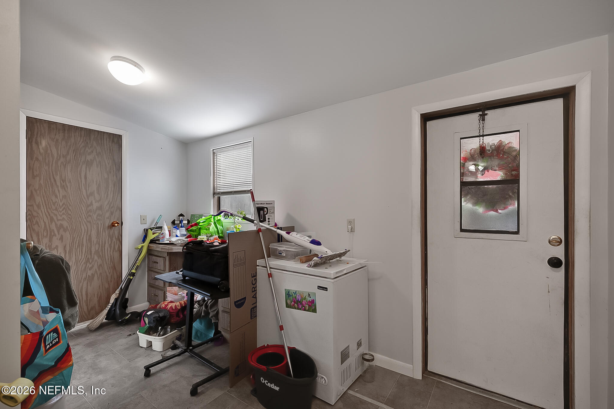 85110 Theresa Road Yulee, FL 32097 - Photo 6 of 24 a view of a workspace with furniture and clutter