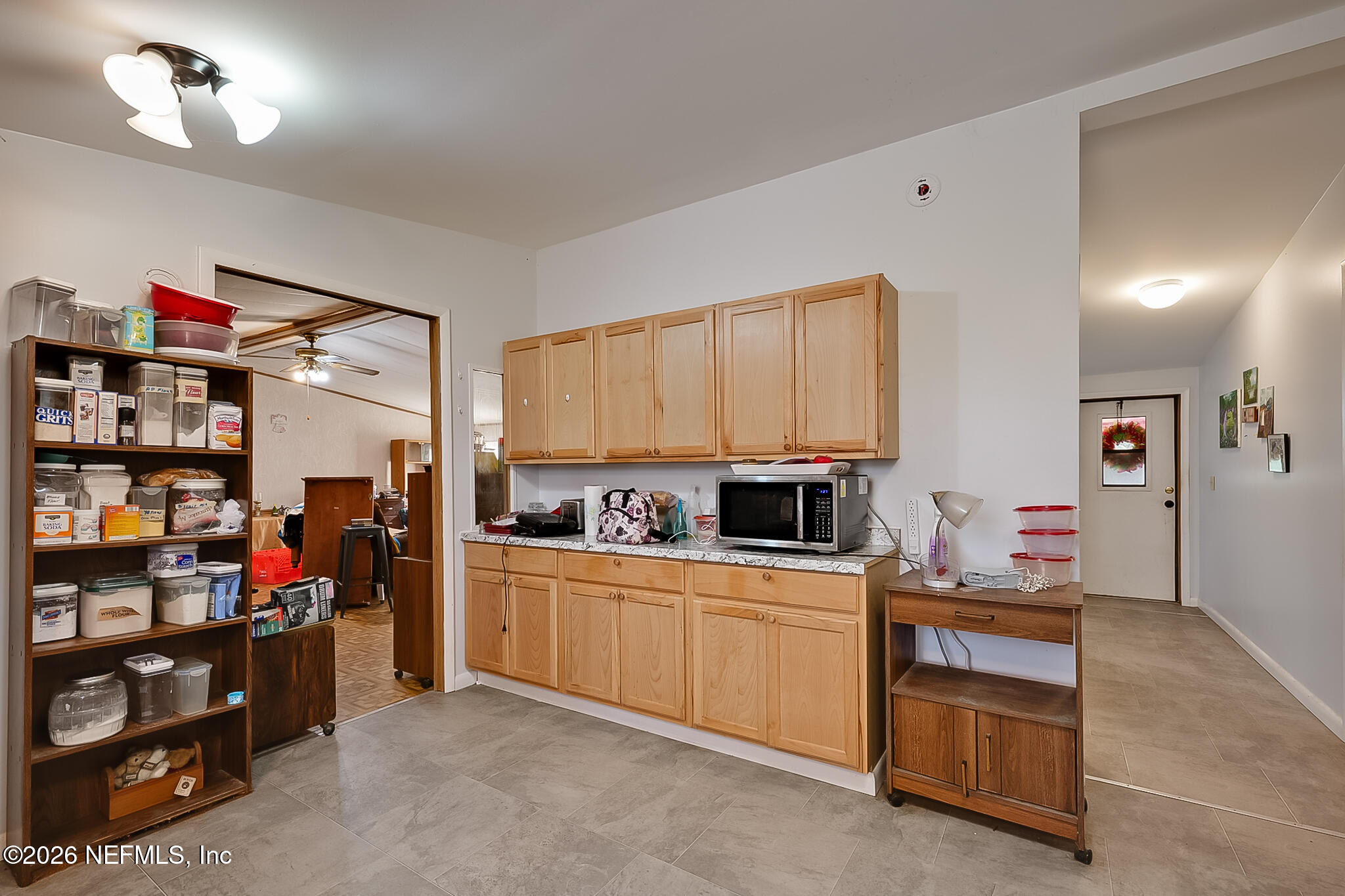 85110 Theresa Road Yulee, FL 32097 - Photo 7 of 24 a view of a kitchen with fridge and workspace