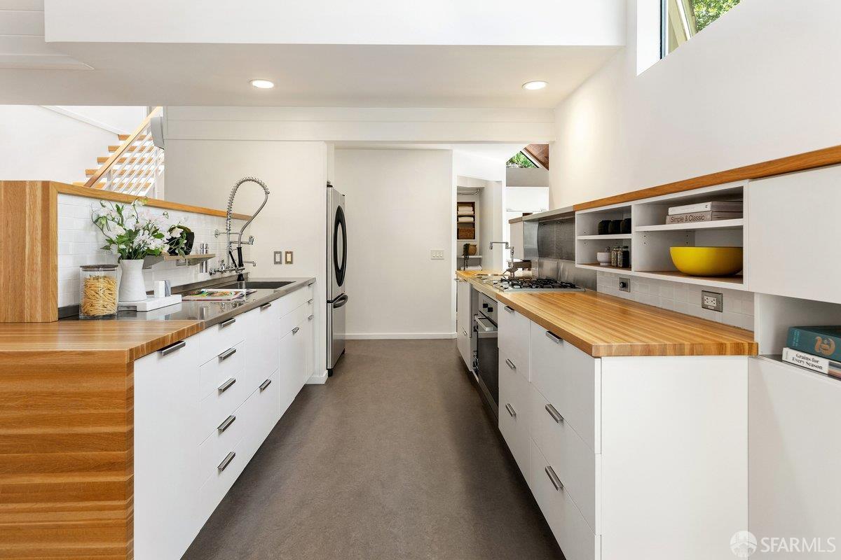 1824 Gouldin Road Oakland, CA 94611 - Photo 9 of 42 a large white kitchen with stainless steel appliances