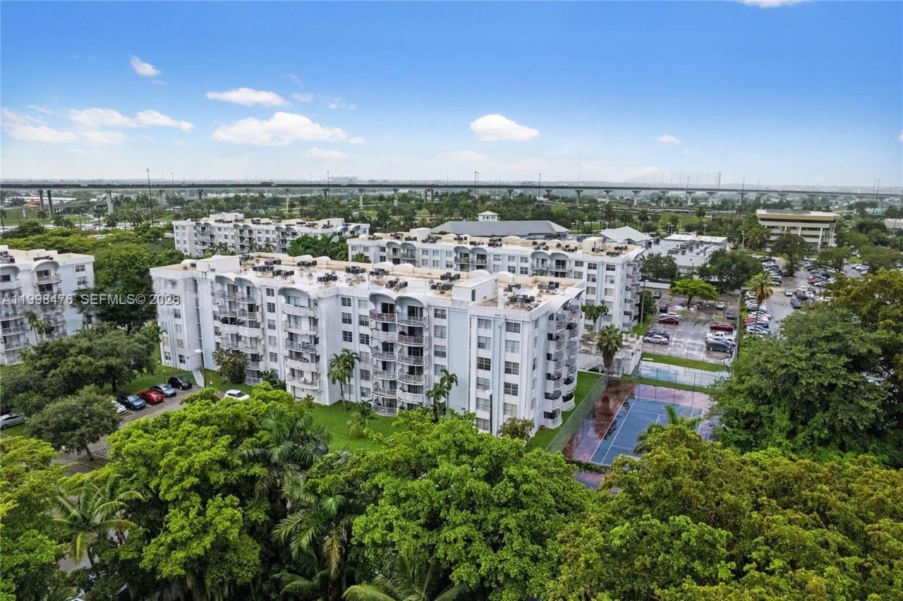 494 Northwest 165th Street, Unit C601 Miami, FL 33169 - Photo 1 of 22 an aerial view of multiple house with yard and ocean view