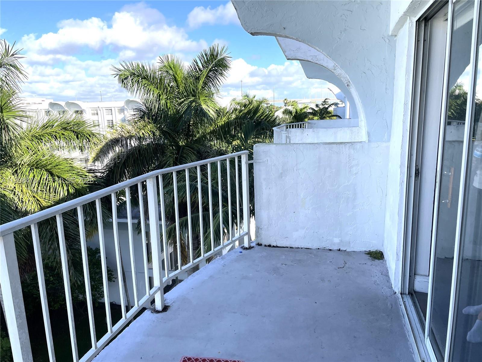 494 Northwest 165th Street, Unit C601 Miami, FL 33169 - Photo 12 of 22 a view of balcony with wooden floor