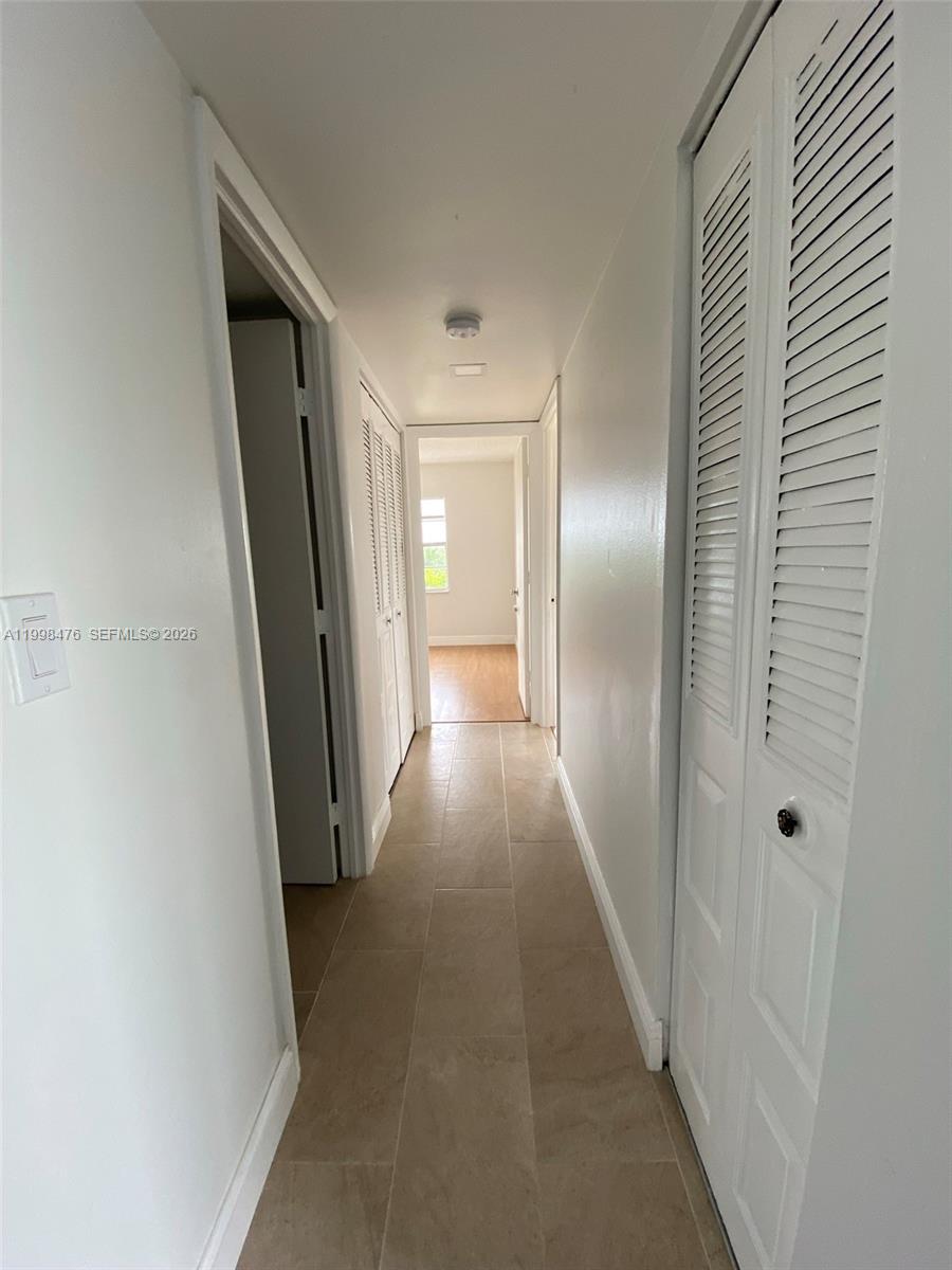 494 Northwest 165th Street, Unit C601 Miami, FL 33169 - Photo 14 of 22 a view of a hallway