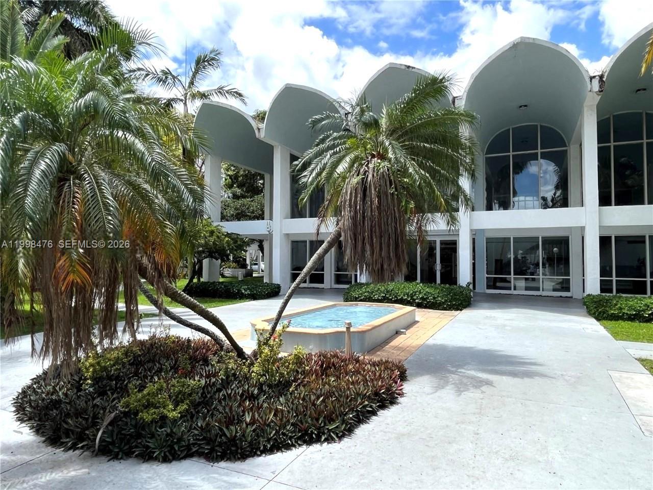 494 Northwest 165th Street, Unit C601 Miami, FL 33169 - Photo 4 of 22 a view of a yard in front of house