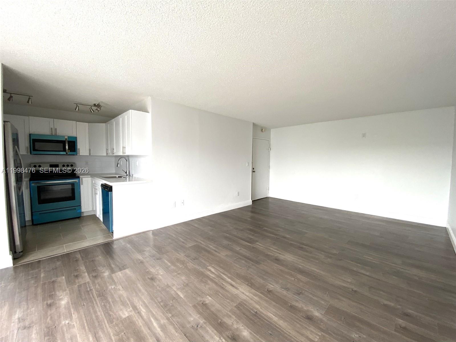 494 Northwest 165th Street, Unit C601 Miami, FL 33169 - Photo 7 of 22 a view of kitchen with wooden floor