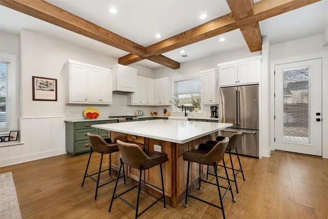 a kitchen with stainless steel appliances granite countertop a stove and a refrigerator