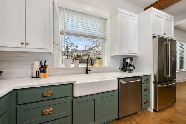 a kitchen with stainless steel appliances granite countertop a sink a stove and a refrigerator